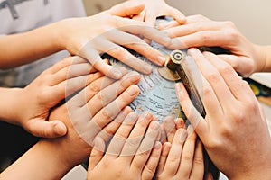 Kids hands together on globe - diversity concept