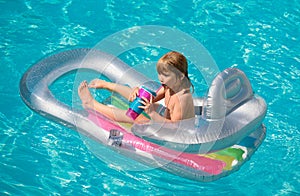 Kids happy summer. Summertime vacation. Child in pool. Boy swimming at swimmingpool. Funny kid on inflatable rubber