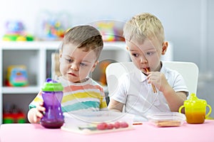 Kids have a lunch in kindergarten