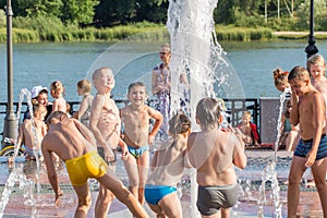 Kids having fun in the fountain on the embankment of the river don in Russia