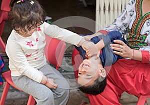 Kids having fun at home, tickling and giggle. photo