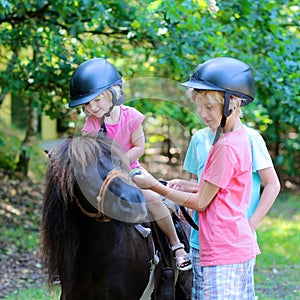 Kids having fun at horse riding summer camp