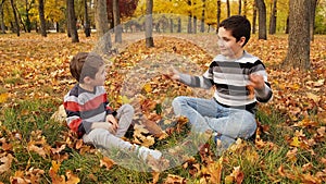 Kids having fun in park. Kids playing in autumn park.