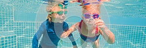 Kids having fun playing underwater in swimming pool on summer vacation BANNER, LONG FORMAT