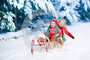 Kids having fun on a sleigh ride in winter