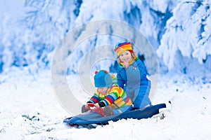 Kids having fun on a sleigh ride in winter