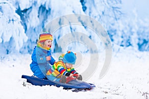 Kids having fun on a sleigh ride in winter