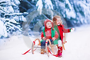 Kids having fun on a sleigh ride in winter