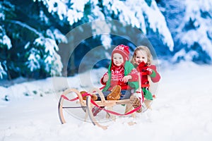 Kids having fun on a sleigh ride in winter