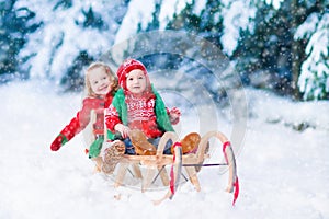 Kids having fun on a sleigh ride in winter