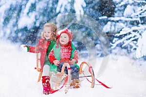 Kids having fun on a sleigh ride in winter