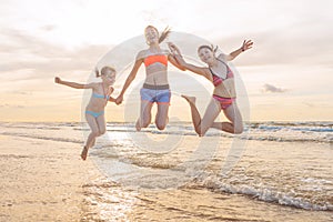 Kids having fun at sunset beach - friendship freedom beach