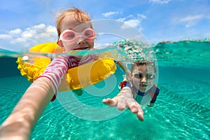 Kids having fun swimming on summer vacation