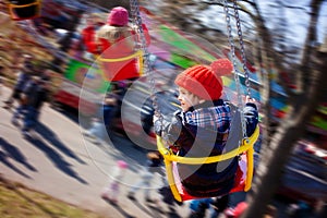 Kids, having fun on a swing chain carousel ride