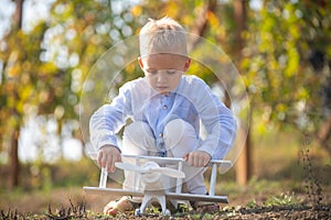 Kids having fun with toy airplane in field against nature background. Adventure and vacations children concept. Summer