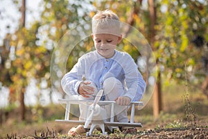 Kids having fun with toy airplane in field against nature background. Adventure and vacations children concept. Summer