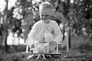 Kids having fun with toy airplane in field against nature background. Adventure and vacations children concept. Summer