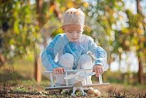 Kids having fun with toy airplane in field against nature background. Adventure and vacations children concept. Summer