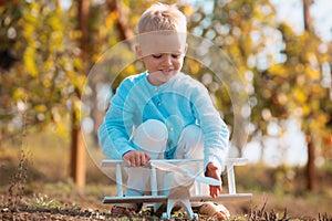 Kids having fun with toy airplane in field against nature background. Adventure and vacations children concept. Summer