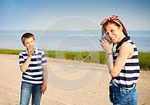 Kids having a phone call with tin cans photo