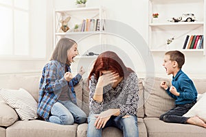 Kids having quarrel over tired mother