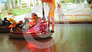 Kids having a ride in the bumper car at the amusement park