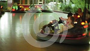 Kids having a ride in the bumper car at the amusement park