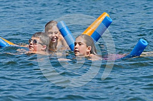 Kids having summer fun swimming in lake