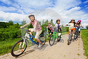 Kids in helmets riding bikes together