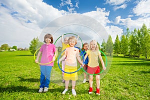 Kids hold hula hoops during exercising activity