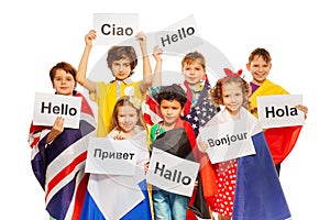 Kids holding greeting signs in different languages