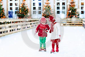 Kids ice skating in winter. Ice skates for child.
