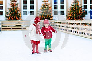 Kids ice skating in winter. Ice skates for child. photo