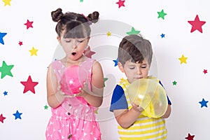 Kids inflates a big bubble from slime.