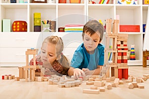 Kids inspecting their wooden block buildings