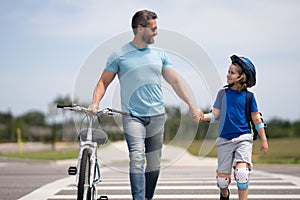 Kids insurance. Safety on road. Pedestrian crossing for cyclists. Happy playful dad with excited kid son riding a