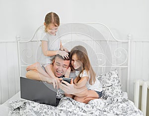 Kids interfere father freelancer work at home bed photo