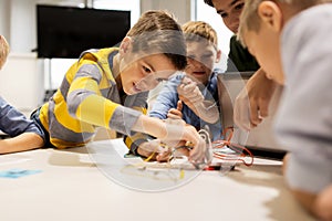 Kids with invention kit at robotics school