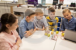 Kids with invention kit at robotics school photo