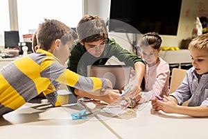 Kids with invention kit at robotics school photo