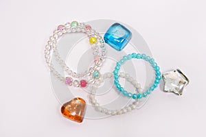 Kids jewellery and colourful stones isolated on white background