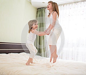 Kids jumping on bed