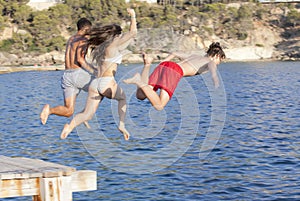 Kids jumping in ocean