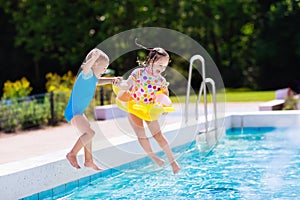 Kids jumping into swimming pool