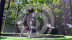 Kids jumping on trampoline, slow motion - 02