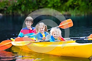 Kids kayaking on a river