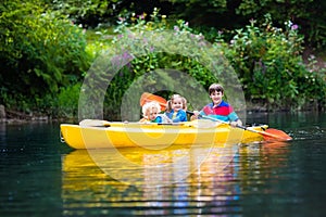 Kids kayaking on a river