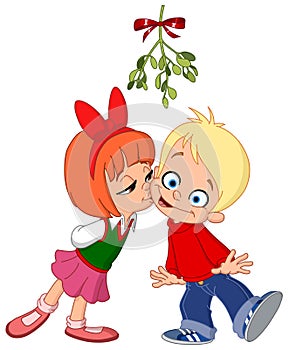 Kids kissing under mistletoe photo