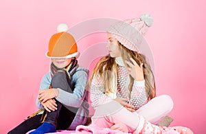 Kids knitted winter hats. Children playful mood christmas holidays pink background. Winter accessories for kids. Girl