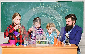 Kids in lab coat learning chemistry in school laboratory. chemistry lab. happy children teacher. back to school. making